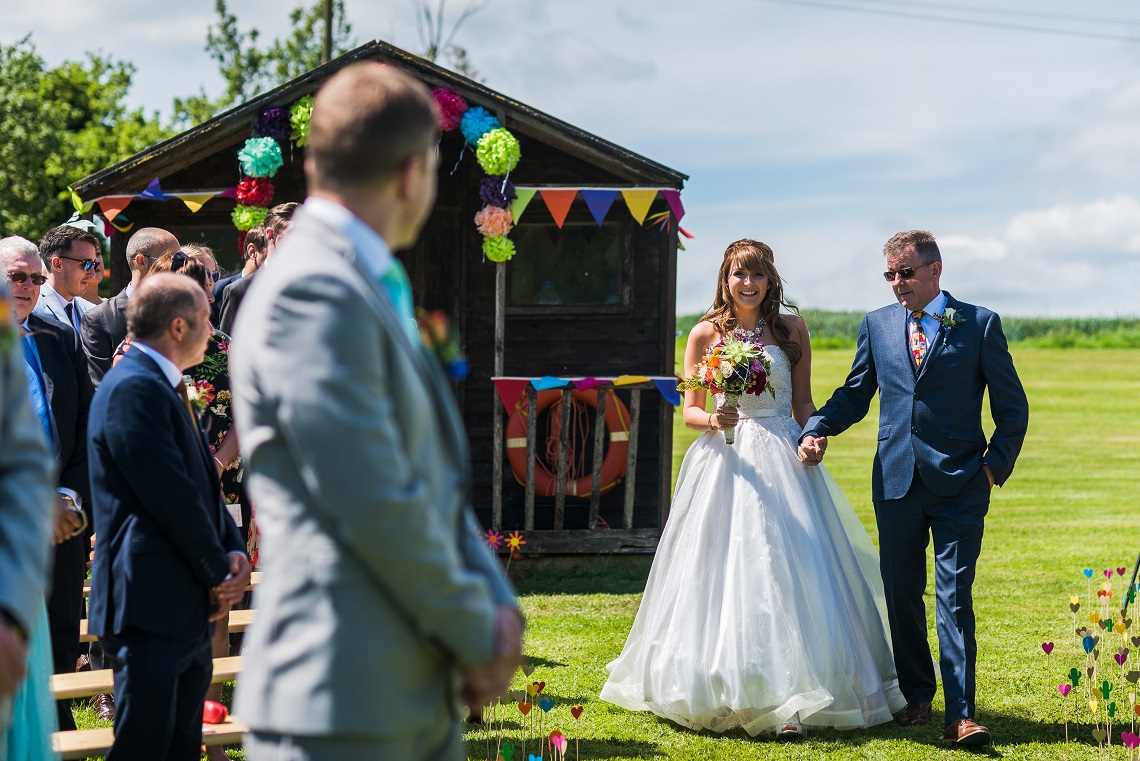 groom watching bride enter